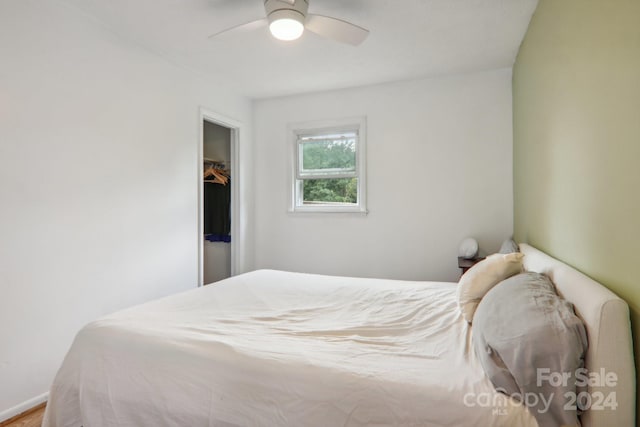 bedroom with ceiling fan and a closet