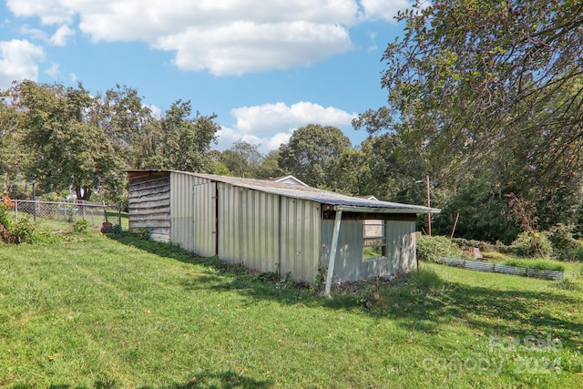 view of outbuilding featuring a yard