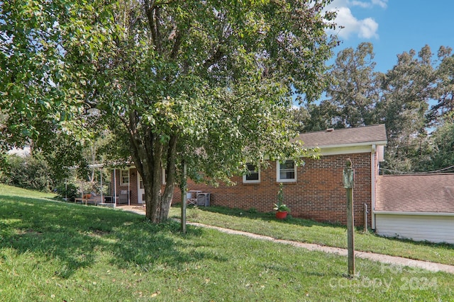 view of side of property with a yard