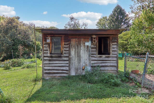 view of outbuilding featuring a yard