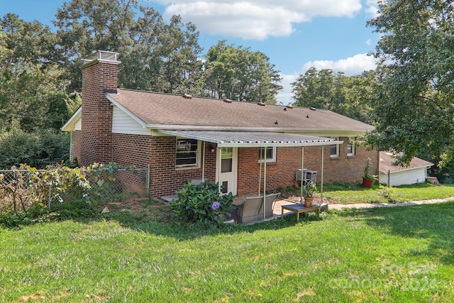 back of house with a lawn