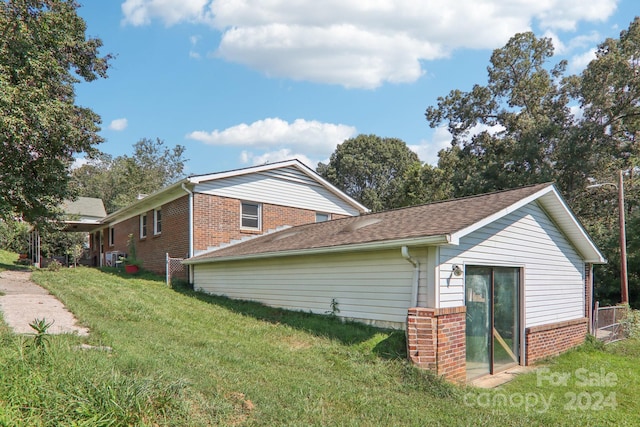 view of property exterior with a yard