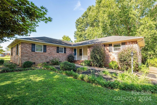 ranch-style home with a front lawn and brick siding