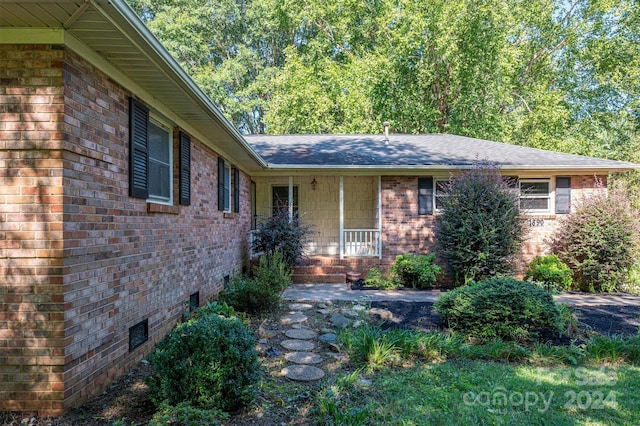 ranch-style home featuring crawl space, a shingled roof, and brick siding