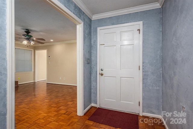 entrance foyer with ceiling fan, parquet flooring, crown molding, and a textured ceiling