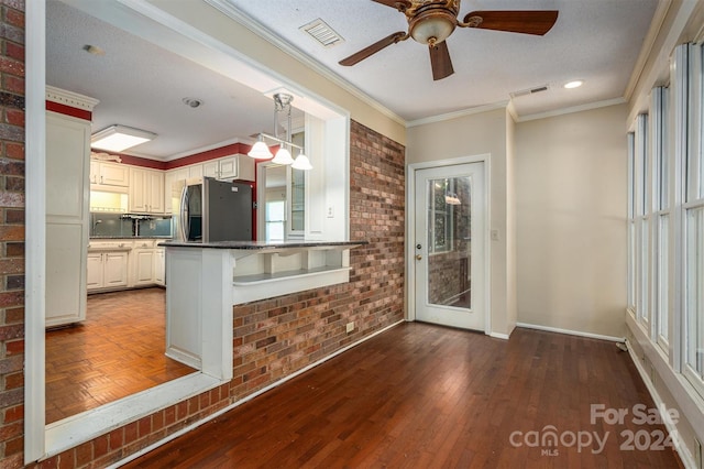 kitchen featuring hanging light fixtures, stainless steel refrigerator, dark hardwood / wood-style floors, kitchen peninsula, and a kitchen breakfast bar