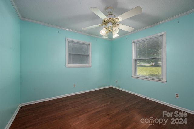 unfurnished room with dark wood-style flooring, crown molding, baseboards, and ceiling fan