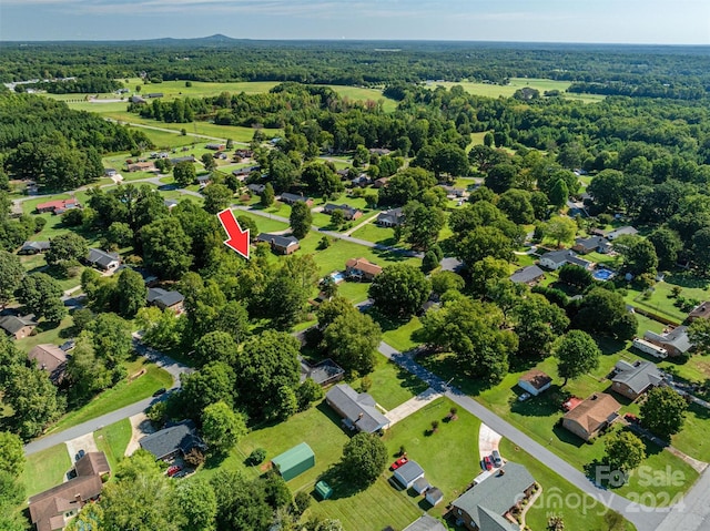 aerial view featuring a wooded view