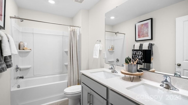 full bathroom featuring double vanity, toilet, and shower / bath combination with curtain