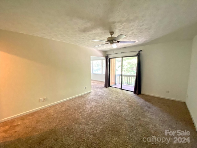 empty room with ceiling fan, a textured ceiling, and carpet floors