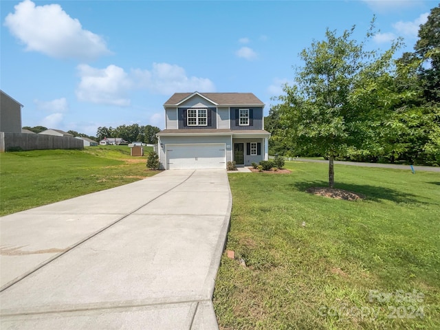 view of front of house featuring a front yard and a garage