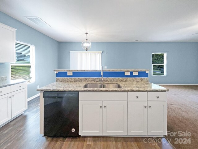 kitchen with pendant lighting, sink, black dishwasher, white cabinets, and light stone countertops