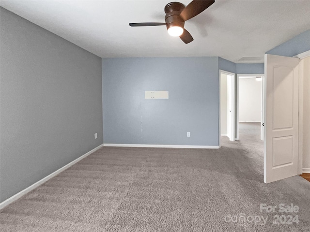 spare room featuring carpet floors and ceiling fan