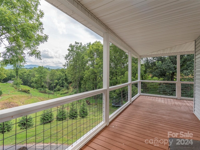 wooden deck featuring a yard