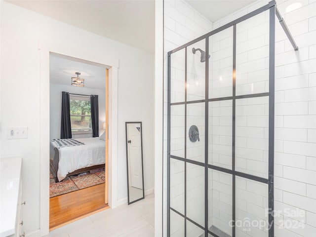 bathroom featuring an enclosed shower and hardwood / wood-style flooring