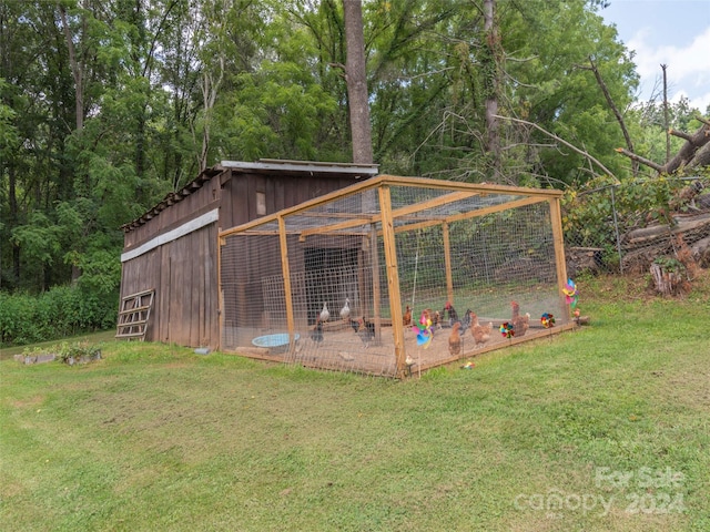 view of outbuilding with a yard