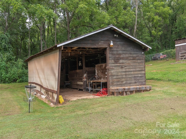 view of outbuilding featuring a lawn