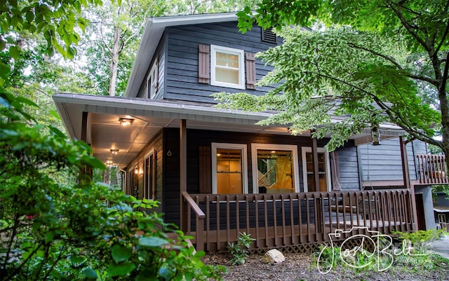 back of house featuring a porch