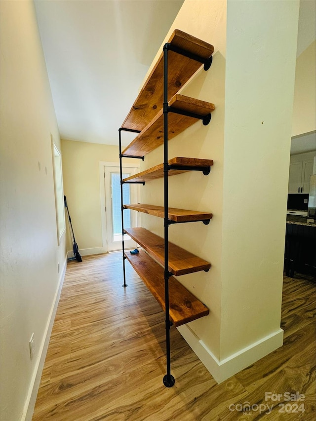 staircase with hardwood / wood-style floors