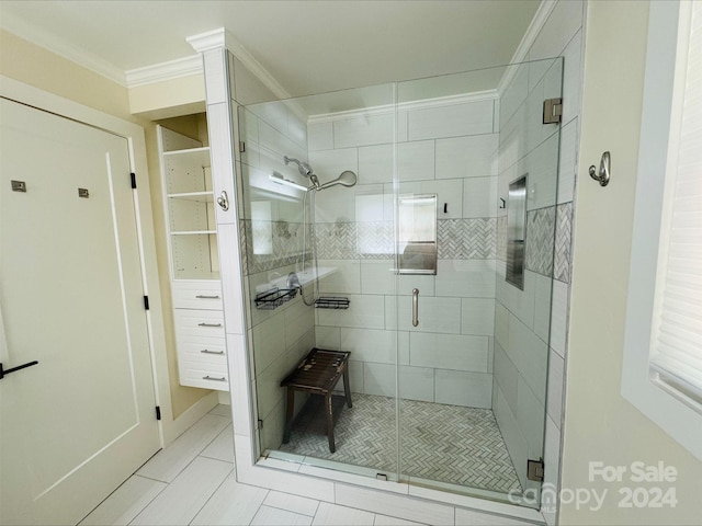 bathroom featuring a shower with door and ornamental molding