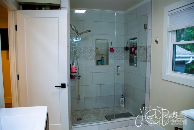 bathroom featuring vanity, ornamental molding, and a shower with shower door