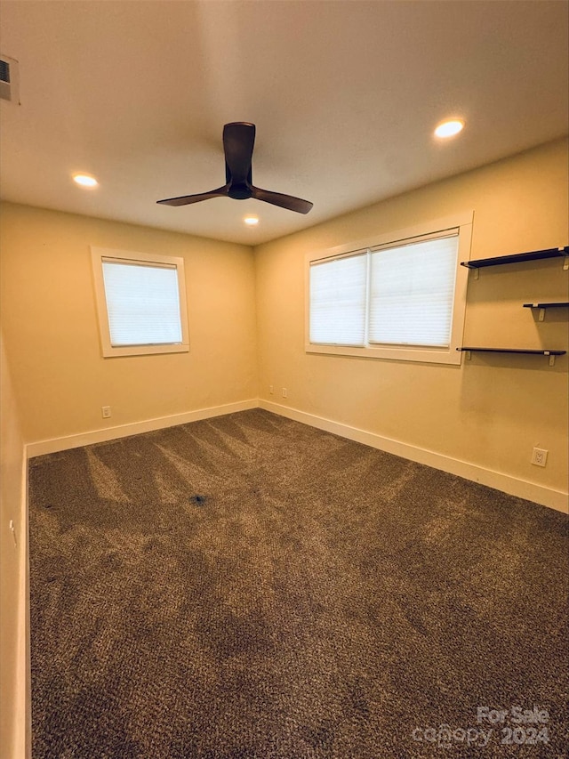 carpeted empty room with a healthy amount of sunlight and ceiling fan