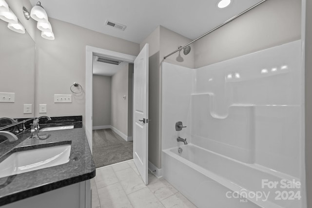 bathroom featuring shower / washtub combination and vanity