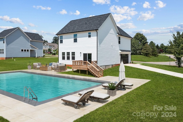 rear view of house featuring a pool side deck, a patio, an outdoor hangout area, and a garage