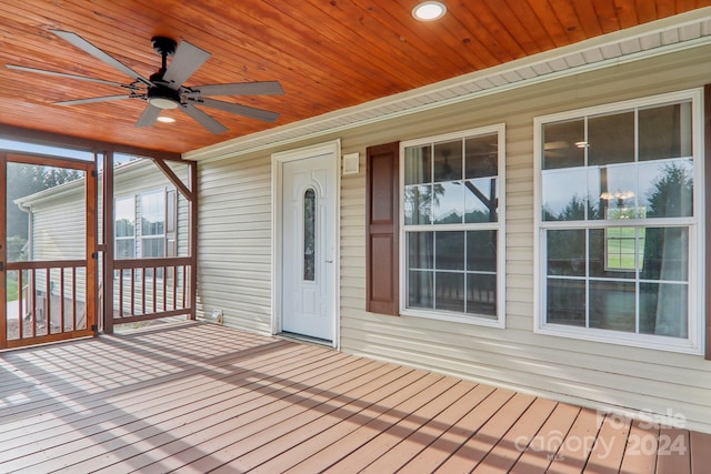 wooden terrace featuring ceiling fan