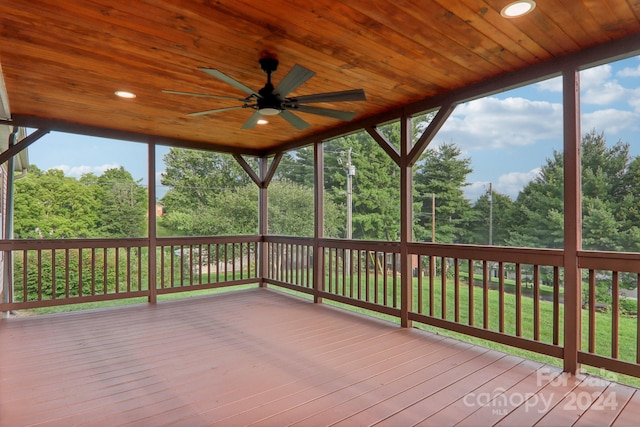 deck featuring ceiling fan and a lawn