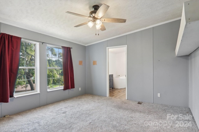 empty room with a textured ceiling, ceiling fan, ornamental molding, and hardwood / wood-style flooring