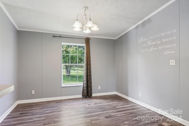 unfurnished room with a healthy amount of sunlight, an inviting chandelier, and hardwood / wood-style flooring