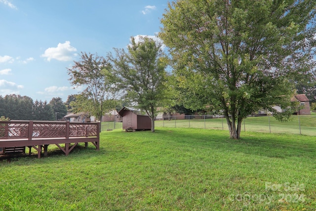 view of yard with a storage unit and a deck