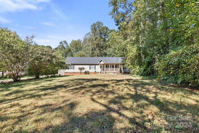 view of front of house with a porch and a front yard