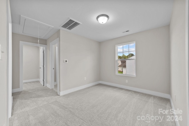 unfurnished room with light colored carpet