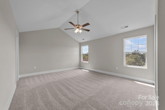 carpeted empty room featuring ceiling fan and lofted ceiling