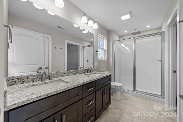 bathroom with tile patterned flooring, toilet, double vanity, and walk in shower