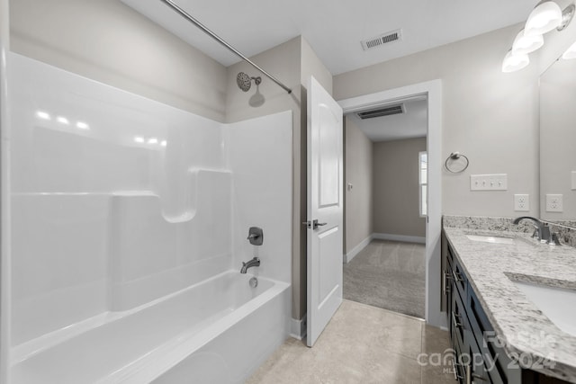 bathroom featuring tile patterned flooring, bathtub / shower combination, and dual vanity