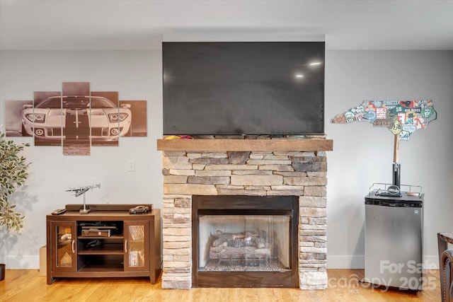 58 Greenwood Fields Dr, Asheville, NC 28804 - interior details featuring wood finished floors, a fireplace, stainless steel refrigerator, and baseboards