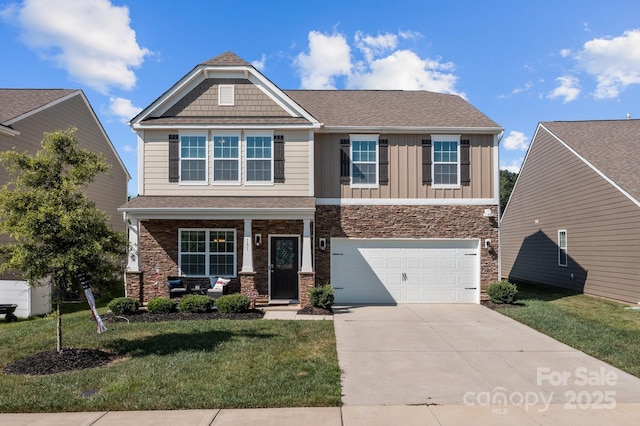 craftsman-style house featuring a garage and a front yard