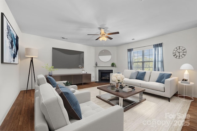 living room featuring hardwood / wood-style floors and ceiling fan