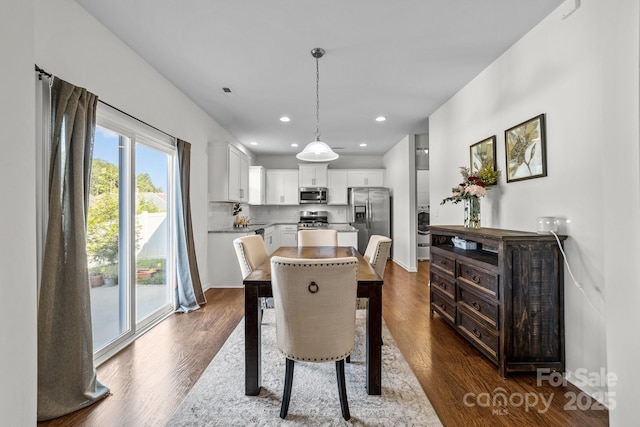 dining space with washer / clothes dryer and dark hardwood / wood-style floors