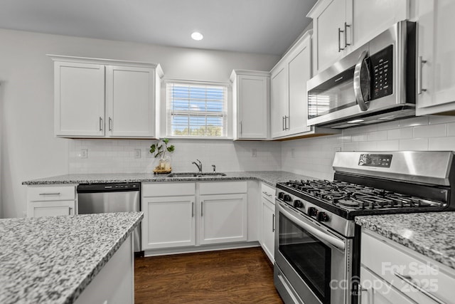 kitchen with sink, white cabinets, and stainless steel appliances