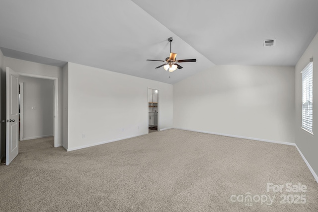 carpeted empty room with ceiling fan and vaulted ceiling