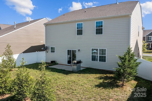 rear view of house with a yard and a patio