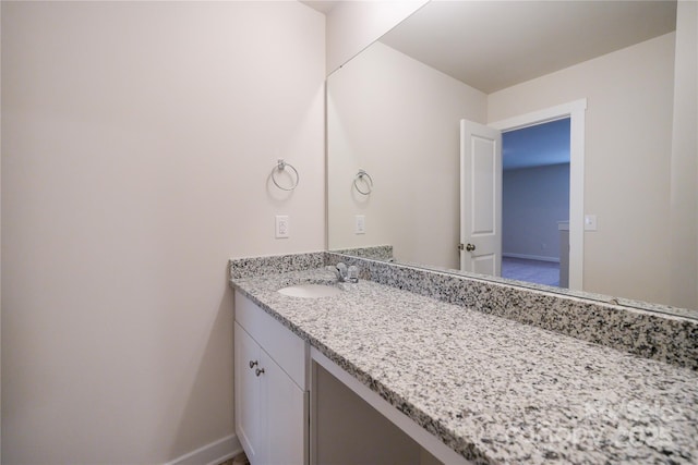 bathroom featuring vanity and baseboards