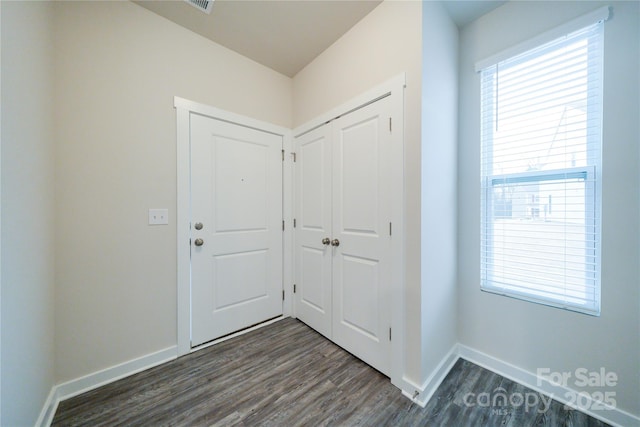 entryway featuring dark wood-style floors and baseboards