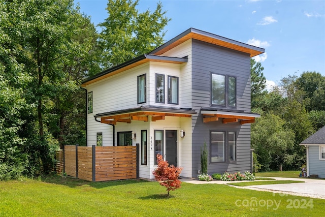 contemporary home with a front lawn