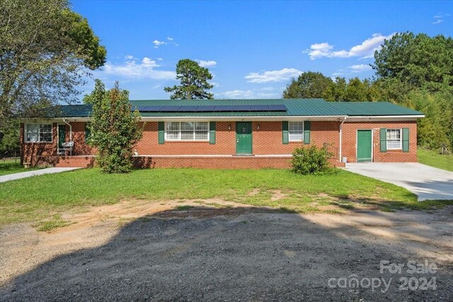 ranch-style house with solar panels