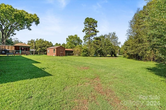 view of yard with a storage unit and an outbuilding